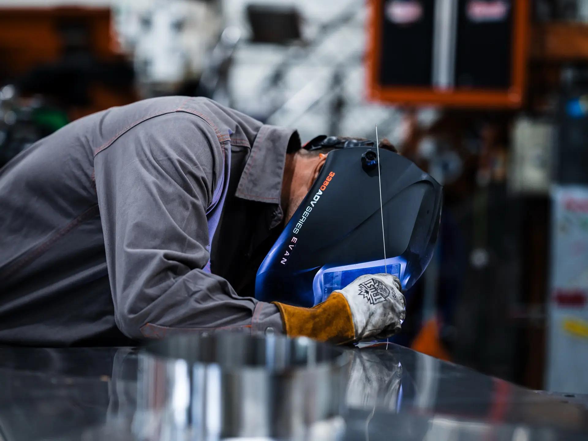 Welding arc glowing blue in the Frozen Fabrication shop