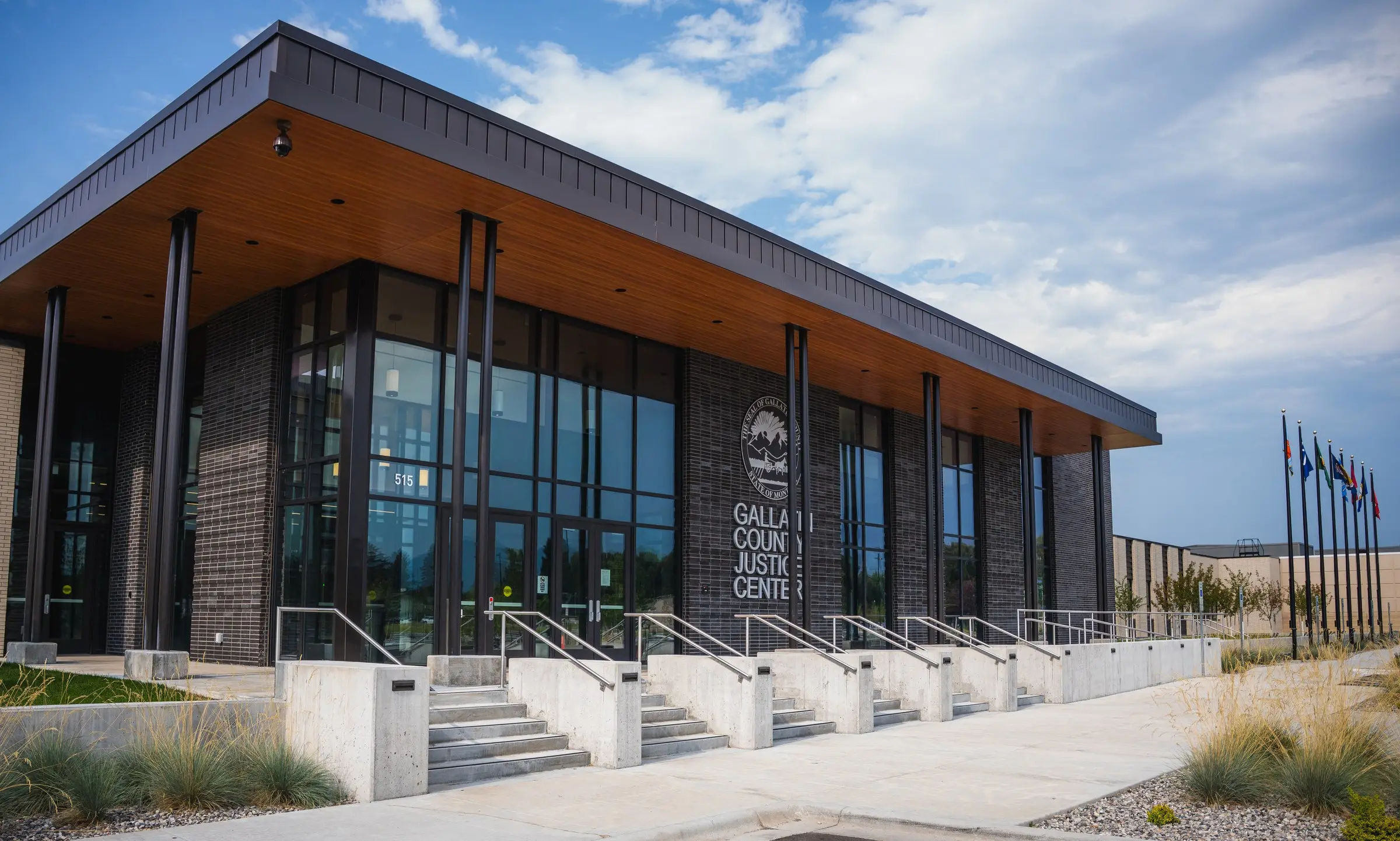 The Gallatin County Justice Center entrance, with stainless steel handrails running along the concrete steps